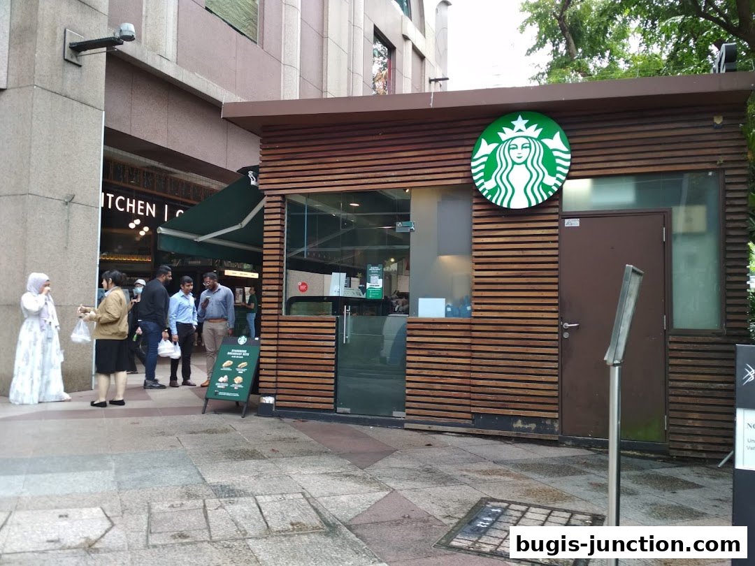 The exterior of a Starbucks coffee shop with its iconic green logo and wooden facade.