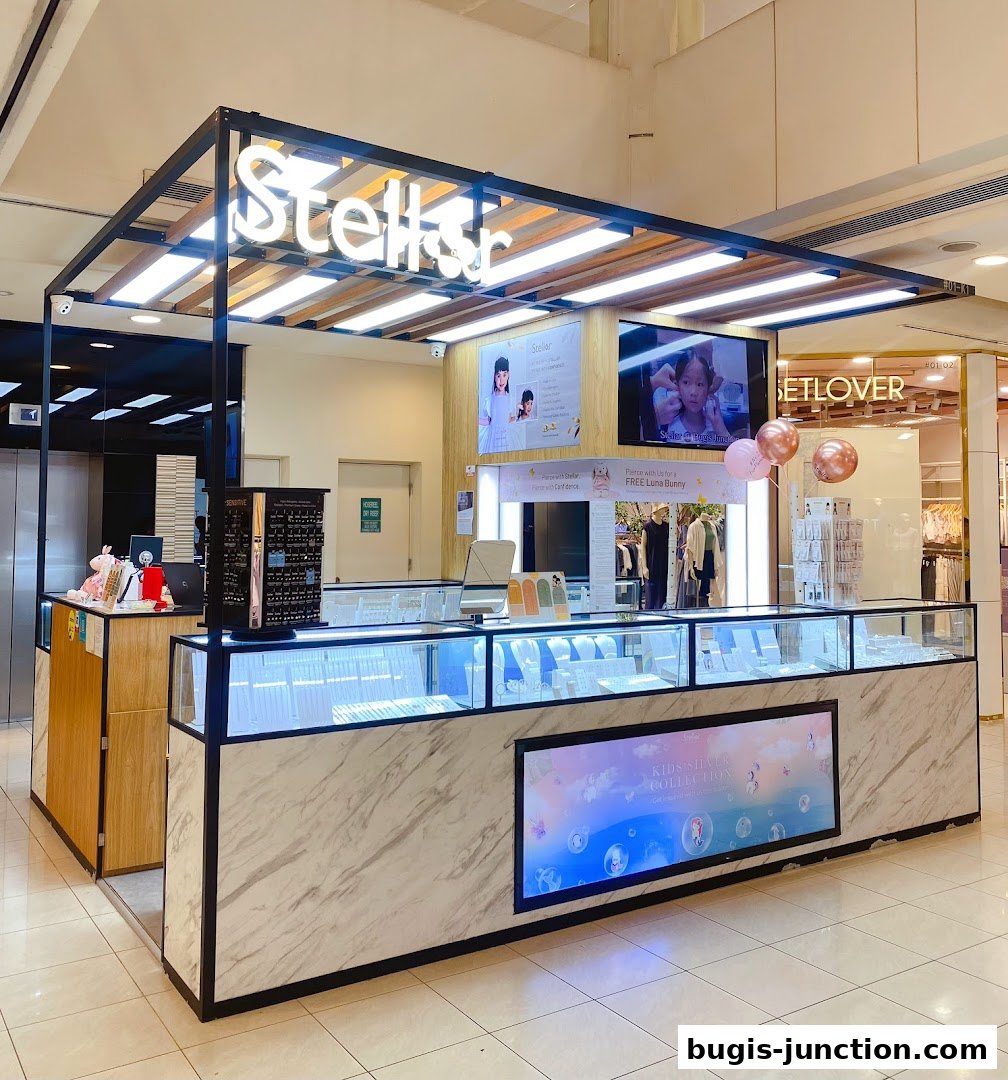 A brightly lit jewelry kiosk with display cases filled with earrings and necklaces.