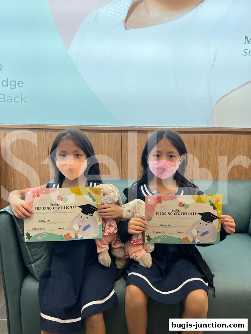 Two young girls in masks hold piercing certificates and stuffed bunnies.