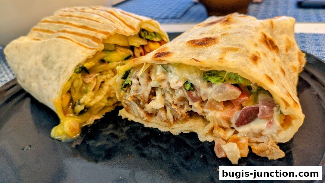A close-up shot of a delicious, generously filled burrito cut in half.