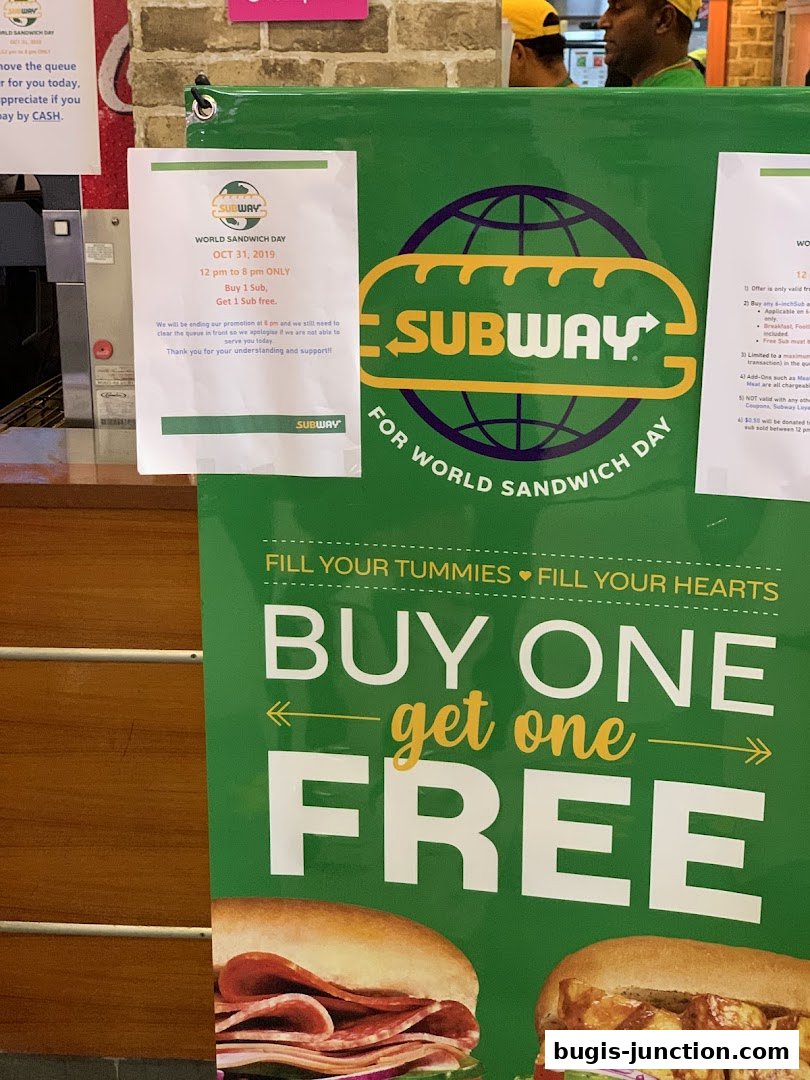A Subway promotional poster for World Sandwich Day offering a buy one, get one free deal.