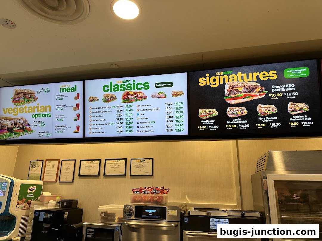 A Subway menu board displaying signature sandwiches, classics, and vegetarian options with prices.