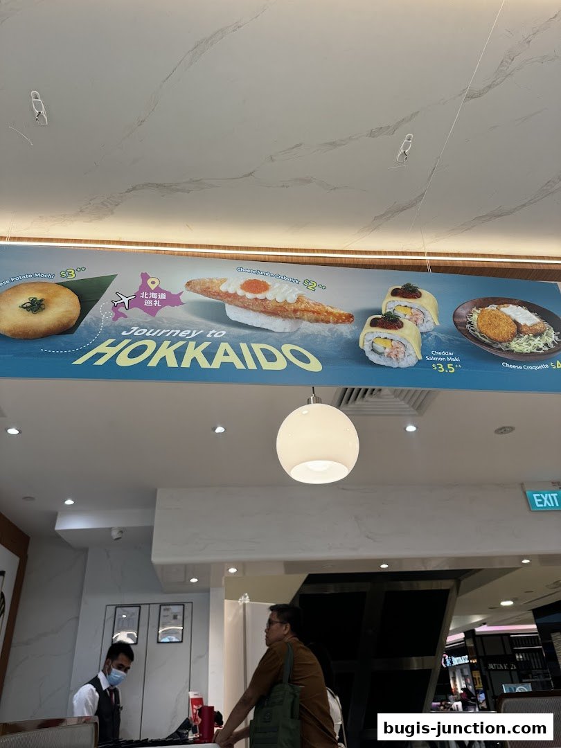 A promotional banner for Sushi Plus featuring Japanese dishes and a Hokkaido theme.