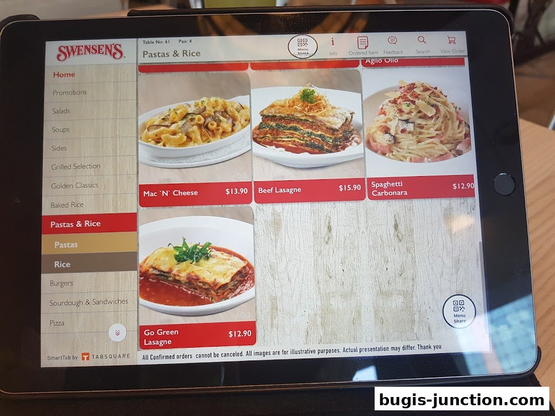 A tablet displaying the Swensen's menu with various pasta and rice dishes.