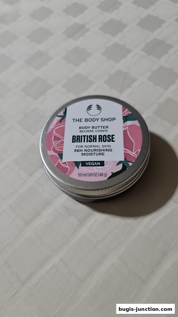 A tin of The Body Shop British Rose Body Butter with floral packaging.