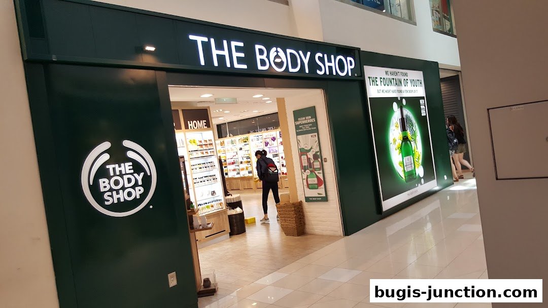 The Body Shop storefront with illuminated signage and product displays visible inside.