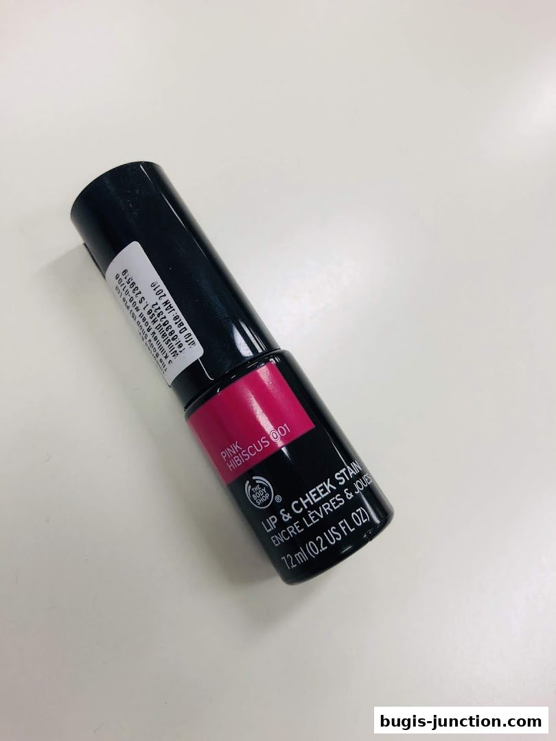 A black tube of The Body Shop Lip & Cheek Stain in Pink Hibiscus.