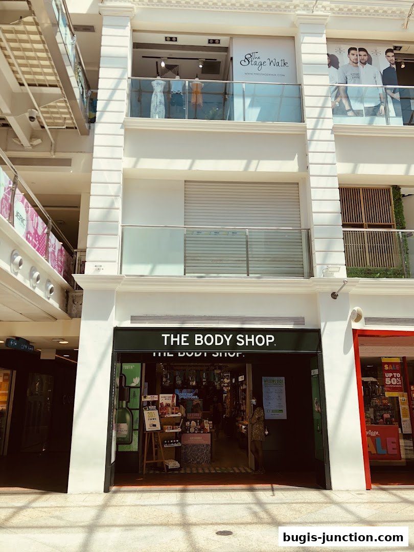 The Body Shop storefront with products displayed inside and a sale sign.