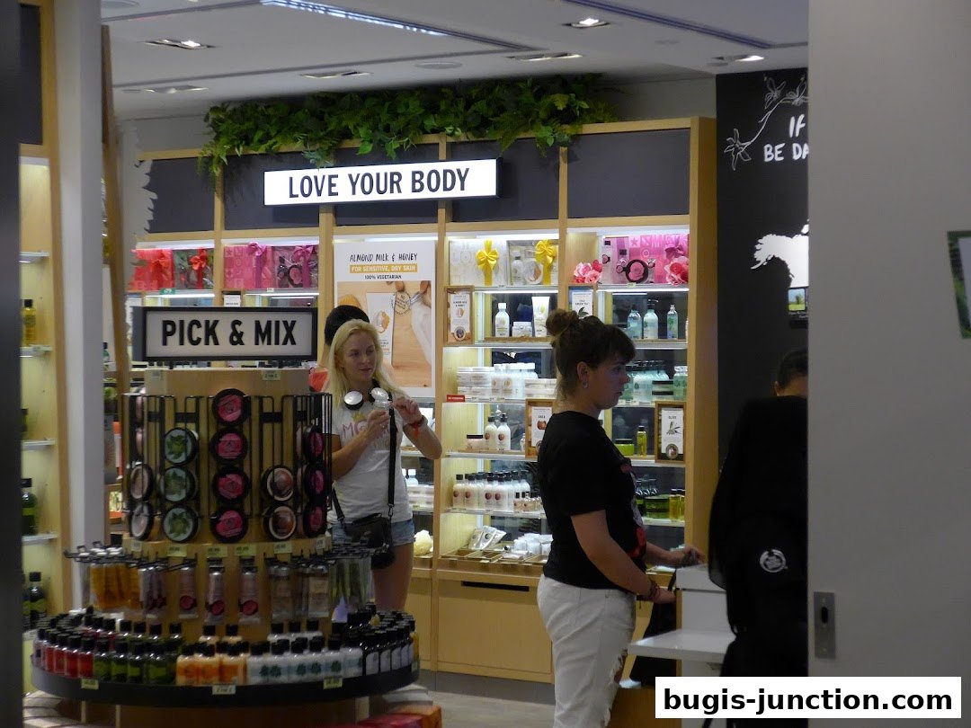 Interior of The Body Shop with customers browsing products and displays.
