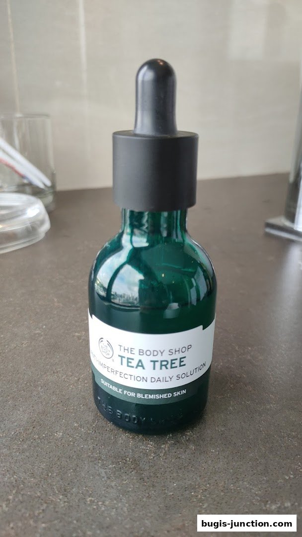 A bottle of The Body Shop Tea Tree Anti-Imperfection Daily Solution.