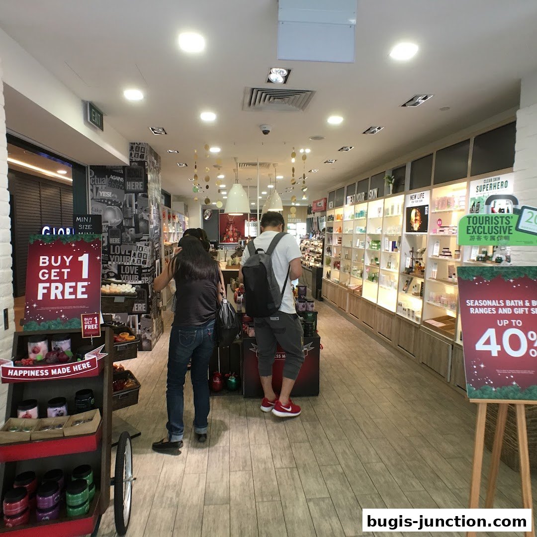 Interior view of The Body Shop with customers browsing products and promotional displays.