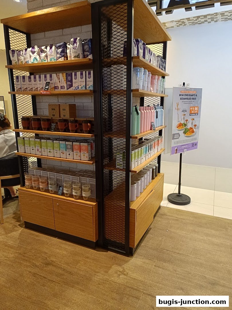 Shelves stocked with coffee, tea, mugs, and water bottles at The Coffee Bean and Tea Leaf.