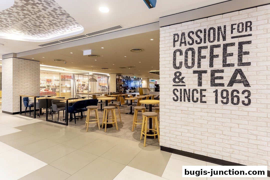 Interior of The Coffee Bean and Tea Leaf with seating and a wall graphic.