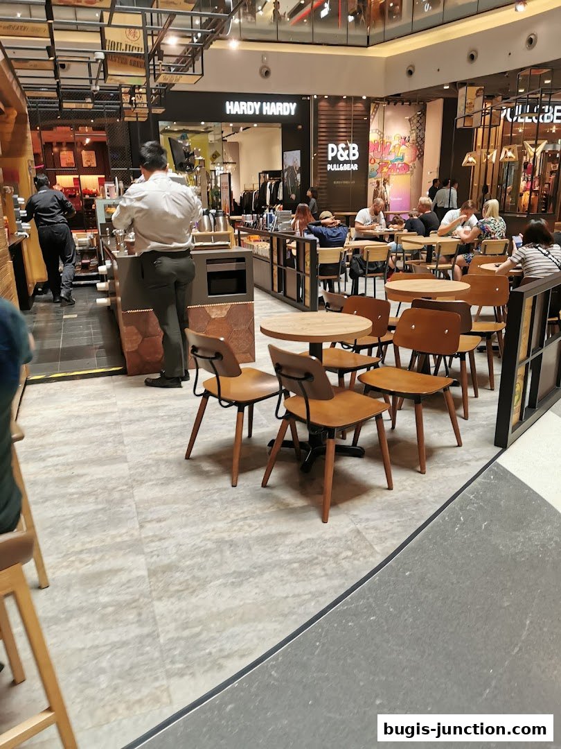 Interior of The Coffee Bean and Tea Leaf with customers seated at tables and staff behind the counter.