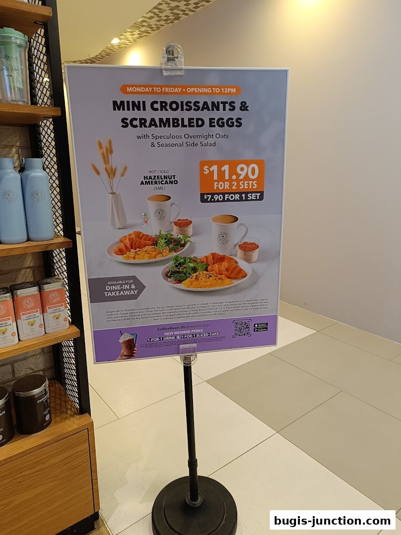A promotional sign for mini croissants and scrambled eggs with hazelnut americano.