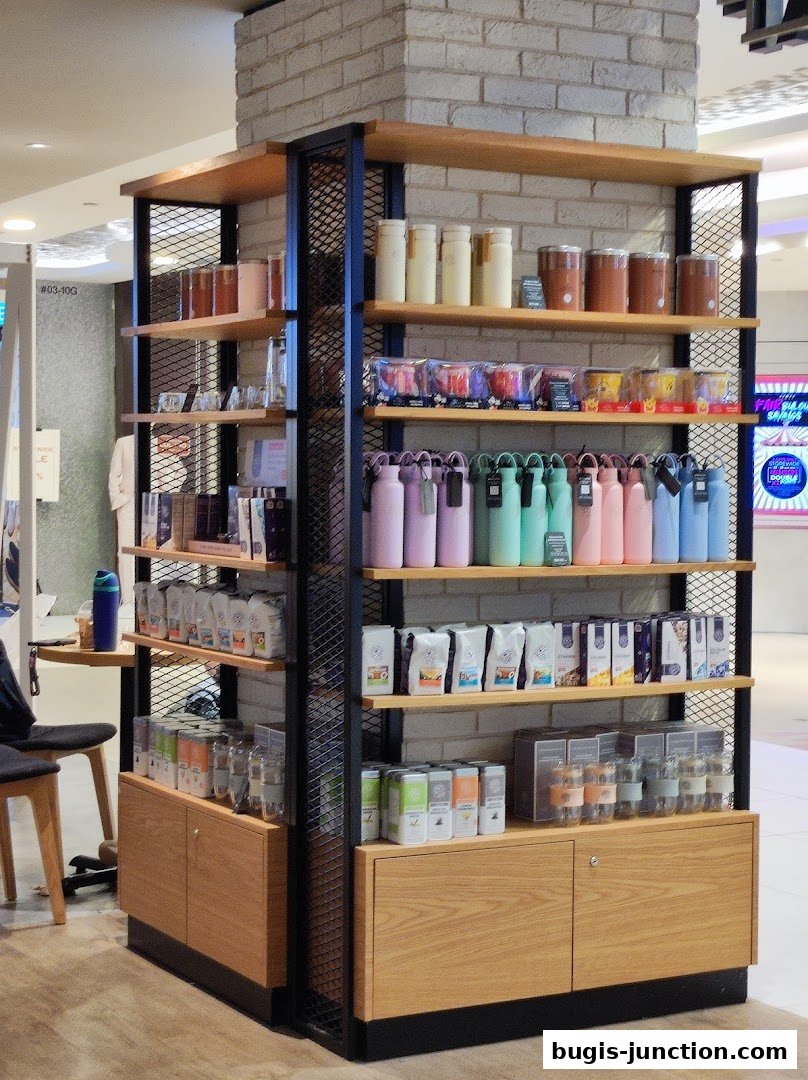 Shelving unit displaying coffee bags, tumblers, and other merchandise at The Coffee Bean and Tea Leaf.