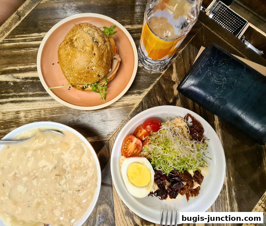 A delicious meal featuring a sandwich, soup, salad, and a drink.