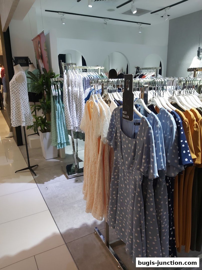 A clothing store interior with racks of polka dot dresses and other women's apparel.