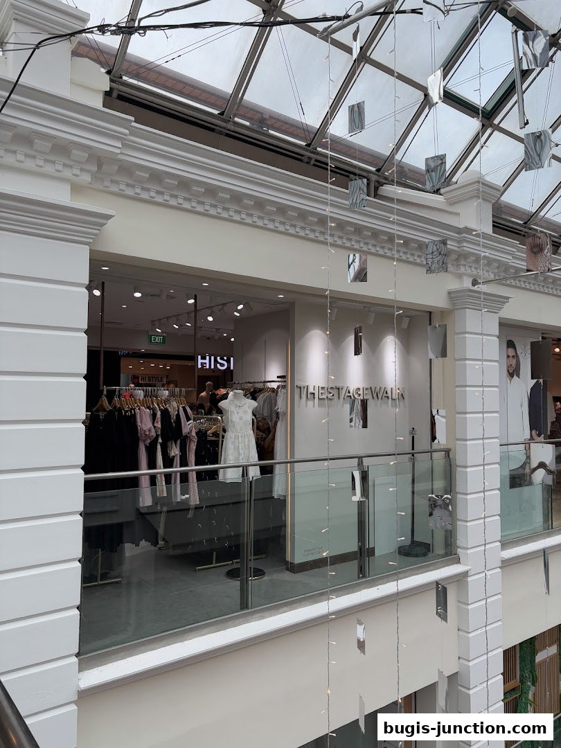 The Stage Walk clothing store interior with mannequins and clothing racks visible.