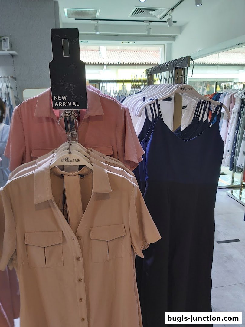 New arrival clothing displayed on hangers inside a retail store.
