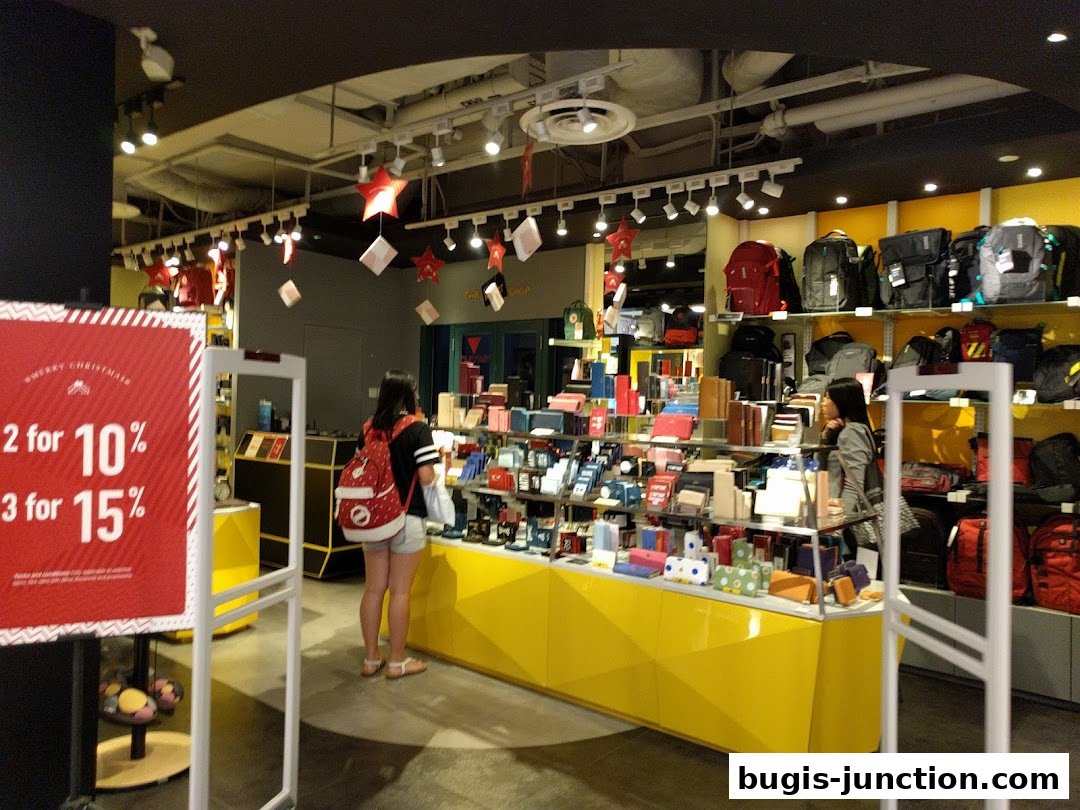 Interior view of The Wallet Shop, showcasing a wide selection of wallets, bags, and accessories with a Christmas promotion.