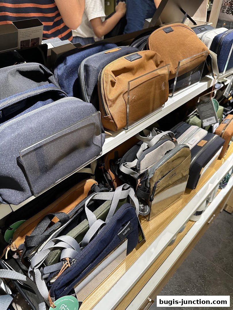 A display of various Bellroy pouches and bags in different colors and sizes.