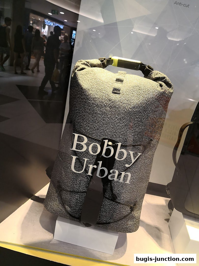 A display window showcases a "Bobby Urban" anti-cut backpack.