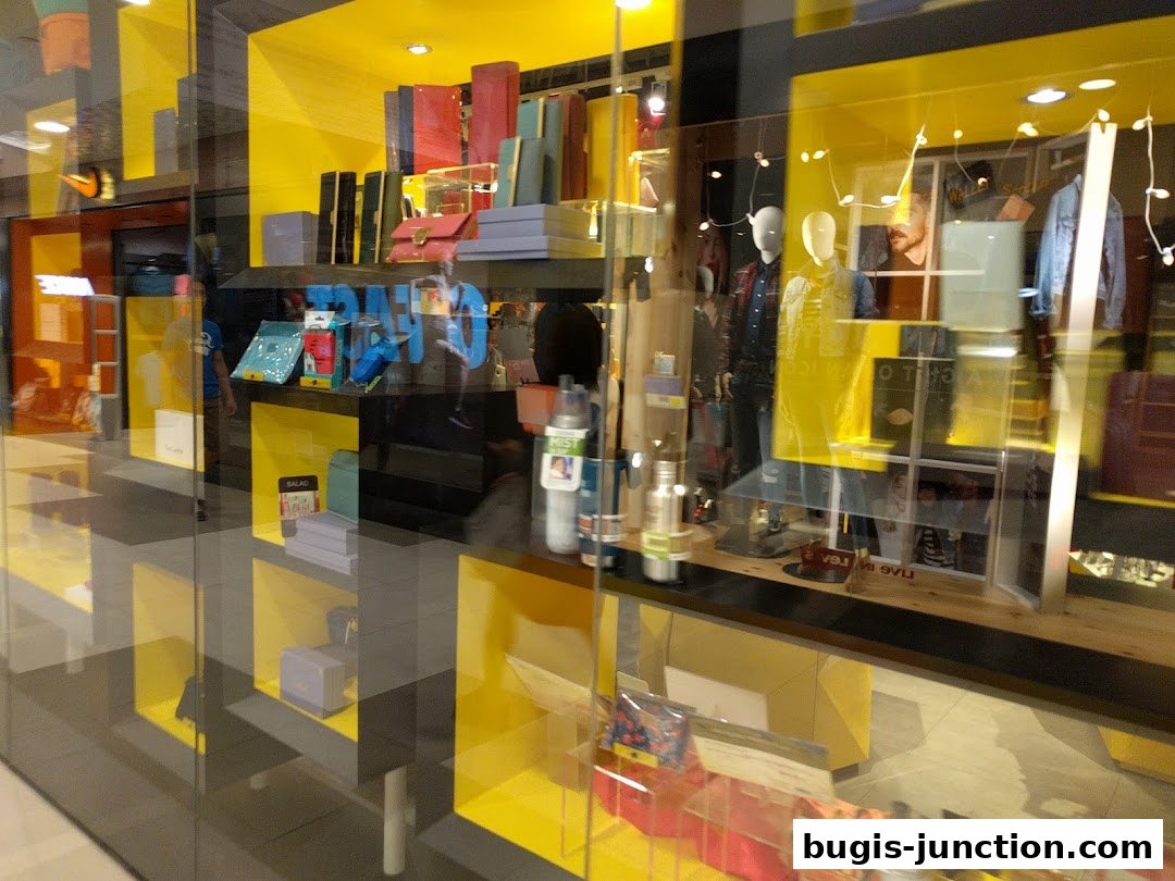The Wallet Shop's vibrant yellow and black storefront displays various accessories and mannequins.