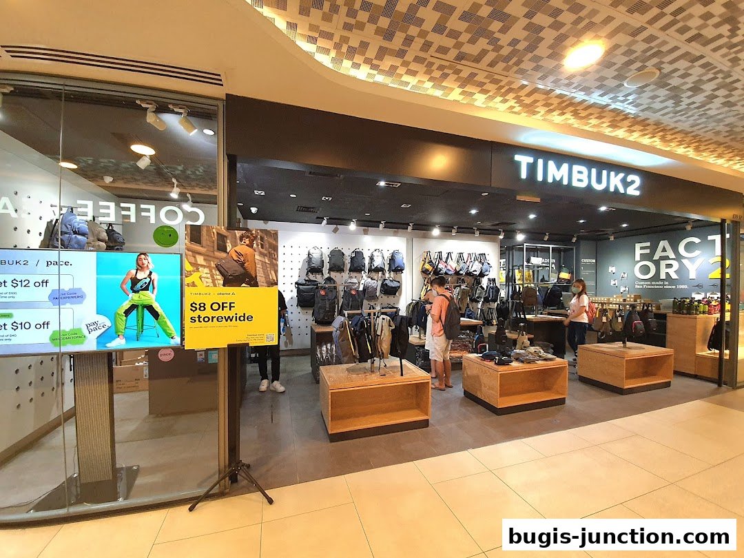 Interior view of a Timbuk2 store showcasing various bags and a promotional display.