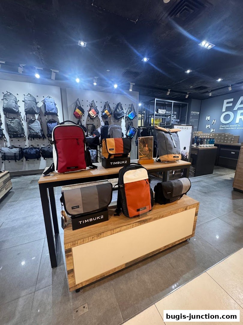 Interior view of a Timbuk2 store showcasing various backpacks and messenger bags on display.