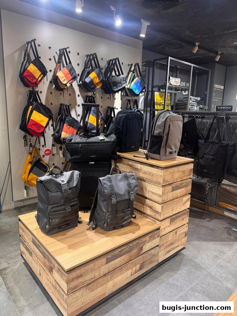 Interior shot of a Timbuk2 store showcasing various backpacks and messenger bags on display.