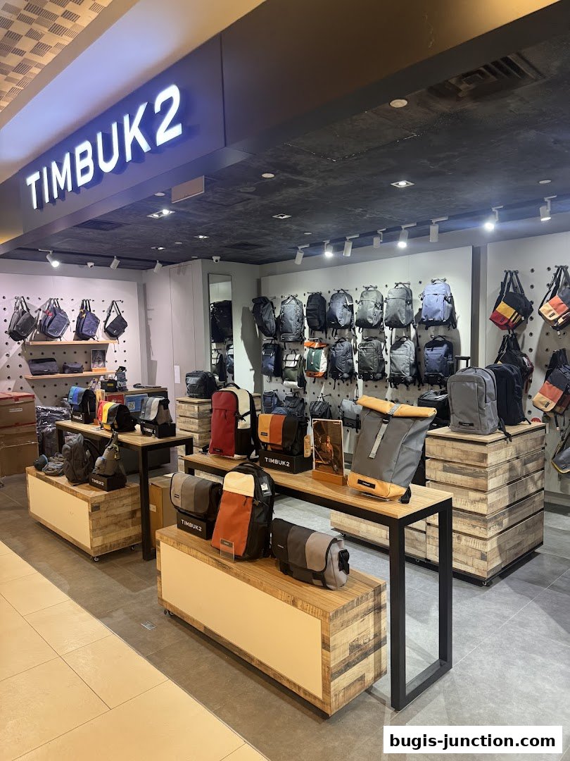 Interior view of a Timbuk2 store showcasing various backpacks and messenger bags on display.