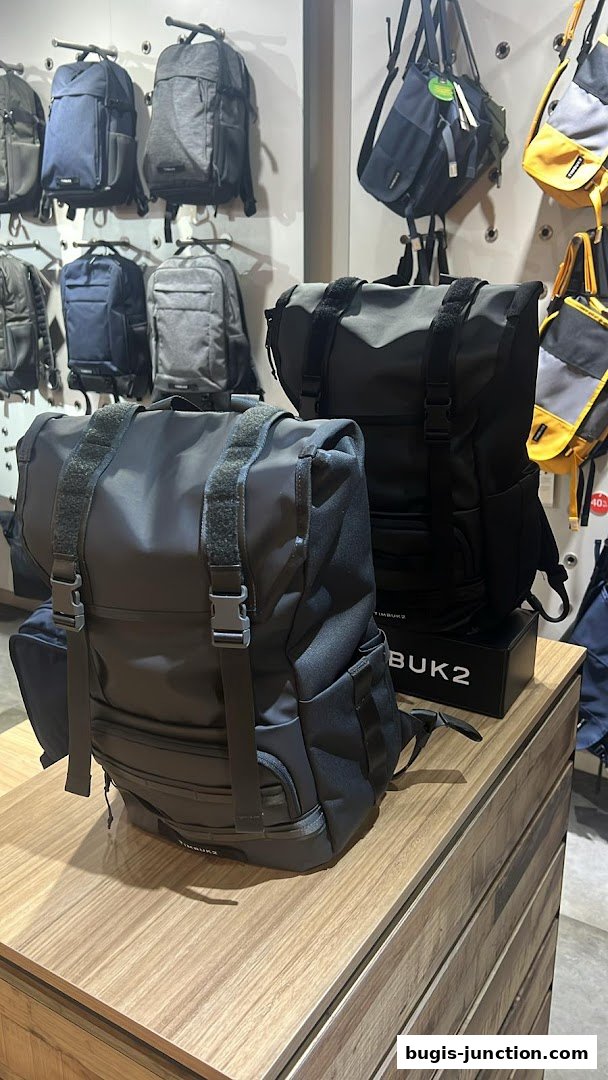 Timbuk2 shop interior displaying a variety of backpacks and bags on shelves and a display table.