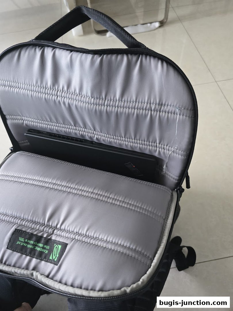 Inside view of a Timbuk2 backpack with a laptop compartment and a branded tag.