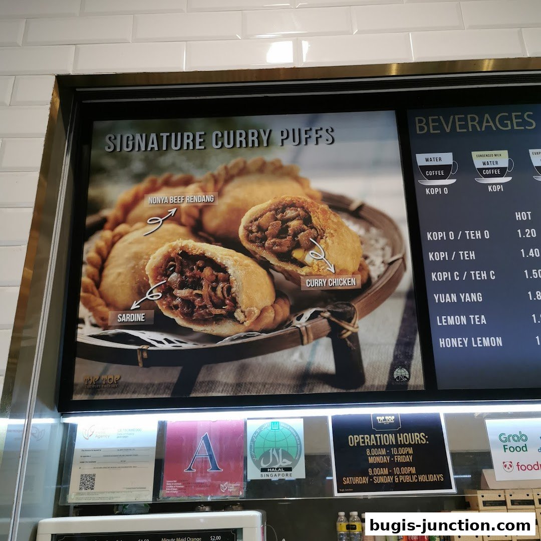 A display showcasing signature curry puffs and beverages with prices.