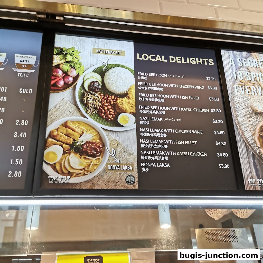 A menu board displaying local delights like Nasi Lemak and Laksa with prices.