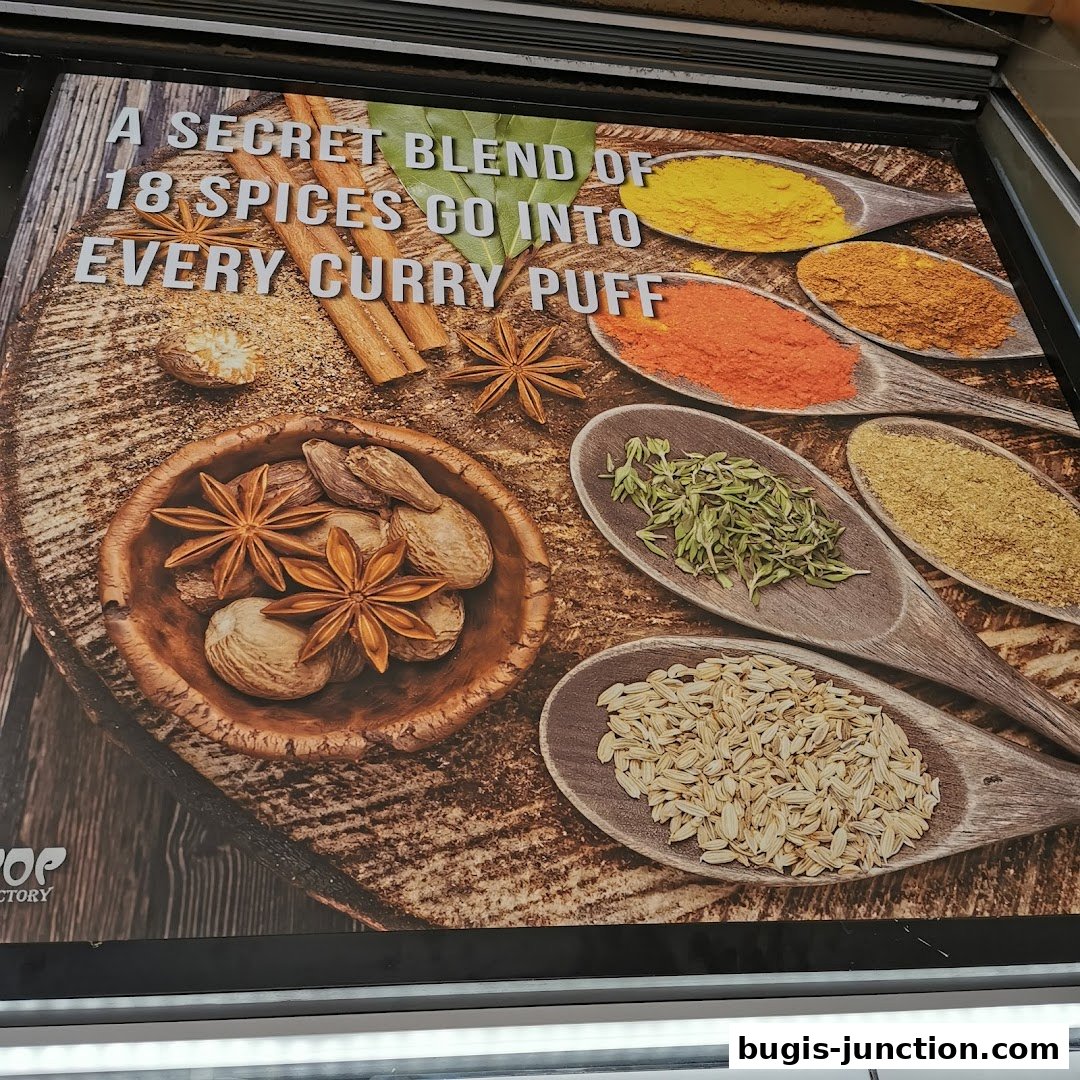 A sign showcasing a secret blend of 18 spices used in curry puffs.