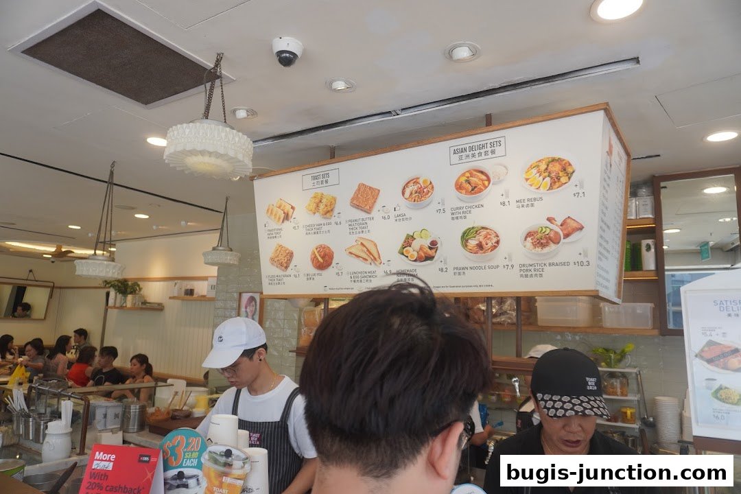 A menu board displaying various Asian delight sets and toast sets with prices.