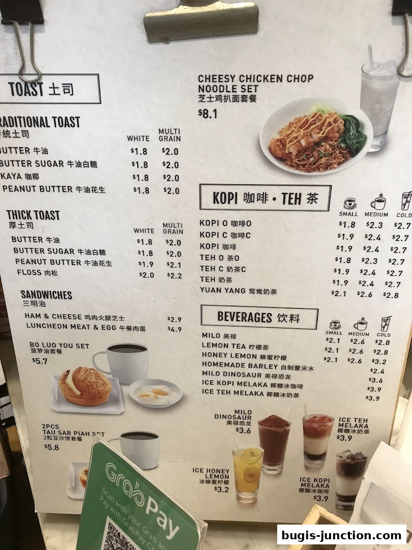 A menu from Toast Box featuring traditional and thick toast, sandwiches, noodle sets, and beverages.