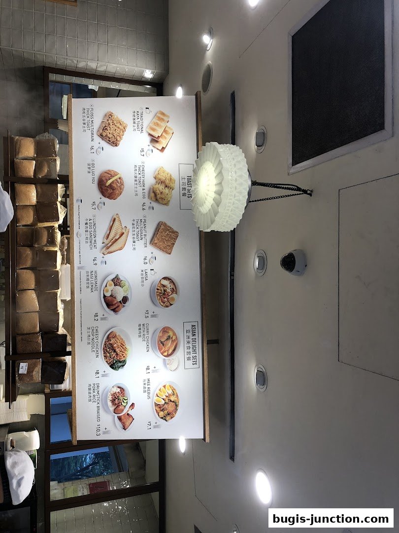 A menu board displaying various toast sets and Asian delight meals with prices.
