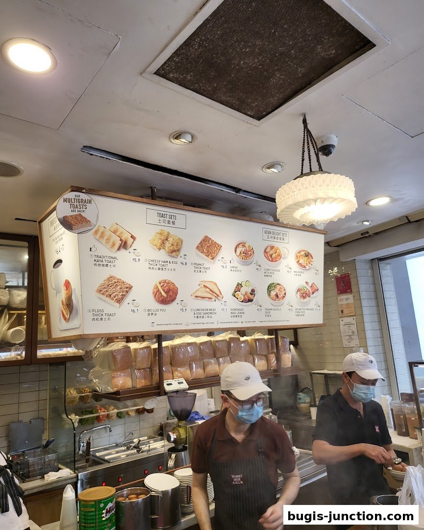 A menu board displaying various toast sets and Asian delights at Toast Box.
