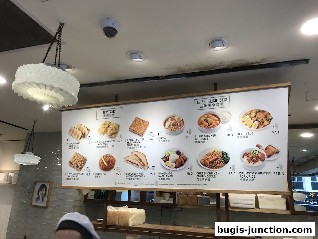 A menu board displaying various toast sets and Asian delight sets with images and prices.