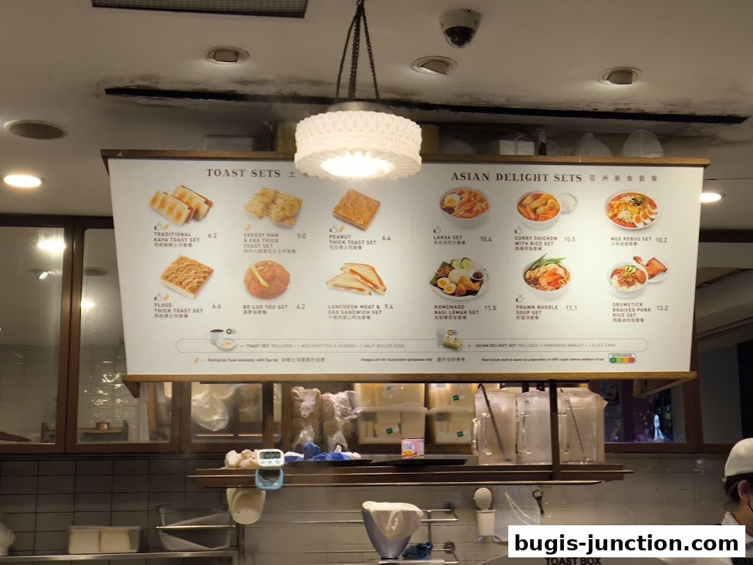 A menu board displaying various toast sets and Asian delight sets with images and prices.