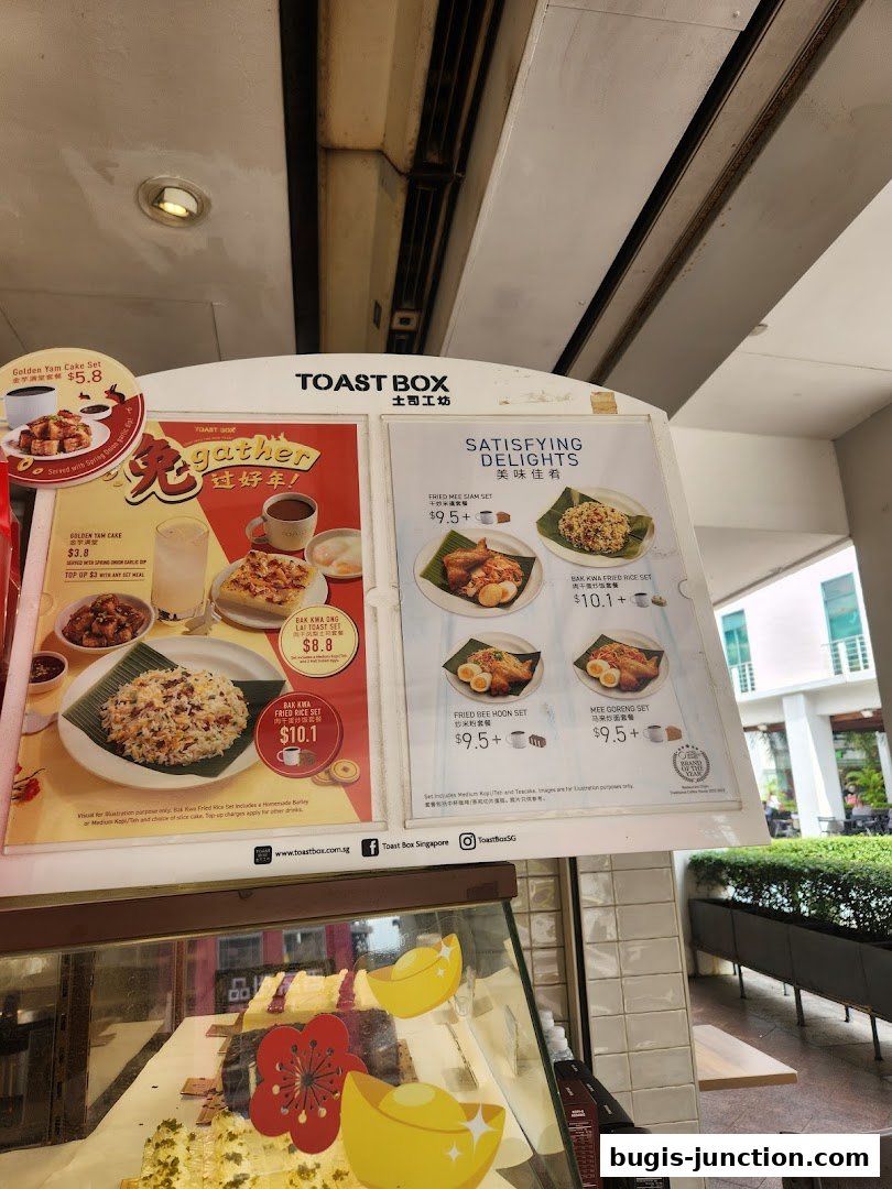 A menu board for Toast Box featuring various sets and dishes with prices.