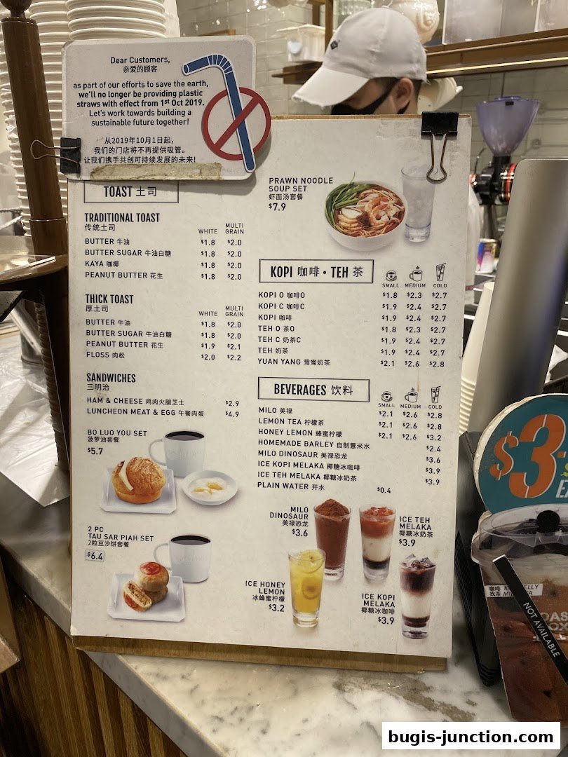 A menu board displaying various toasts, sandwiches, beverages, and sets with prices.