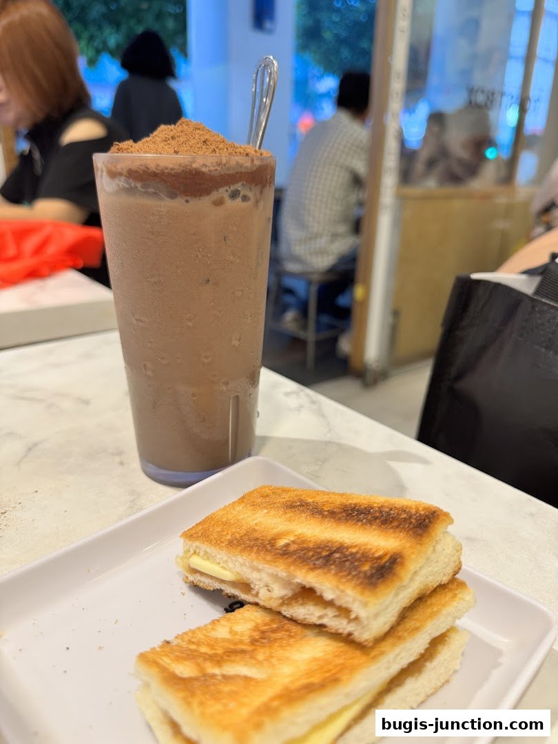 A close-up of kaya toast and a chocolate drink at Toast Box.