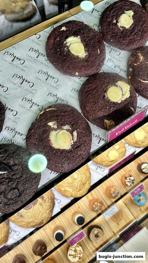 A display of freshly baked cookies, featuring red velvet and chocolate chip varieties.