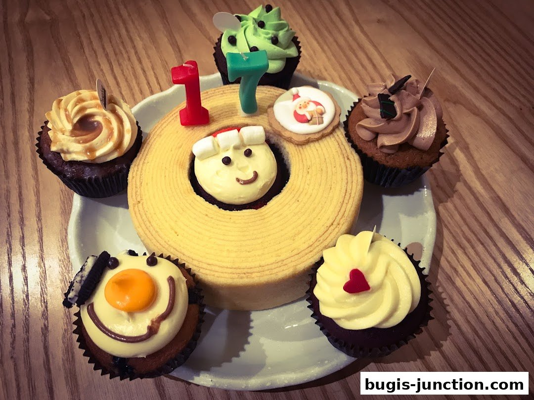 A festive assortment of cupcakes and a ring cake decorated for a celebration.