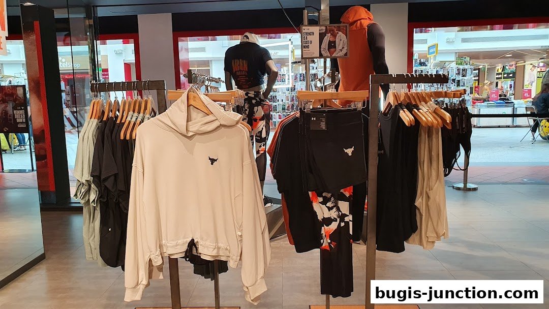 Under Armour shop interior displaying athletic apparel on racks and mannequins.