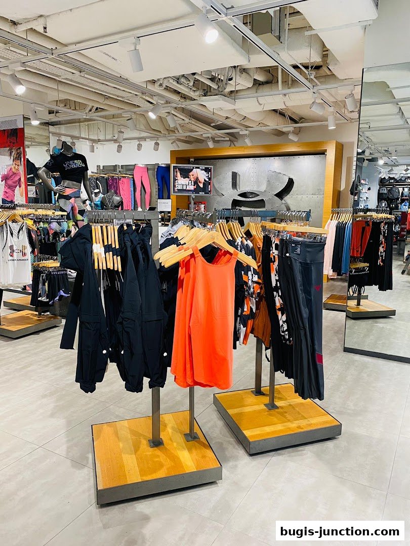 Interior view of an Under Armour store showcasing athletic apparel on display racks.